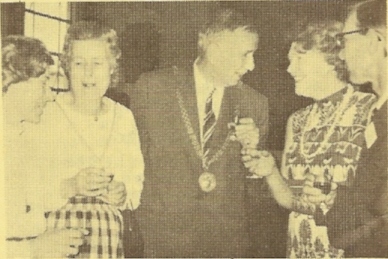 The Mayor of Guildford Lt.-Col. B. E. Tyrwhitt-Drake) with the Mayoress (on his left) enjoying a joke with another of the guests - and the secretary of the Guildford D.G. (Mr. Alan Smith). Mrs. Pauline Smith is on the extreme left
